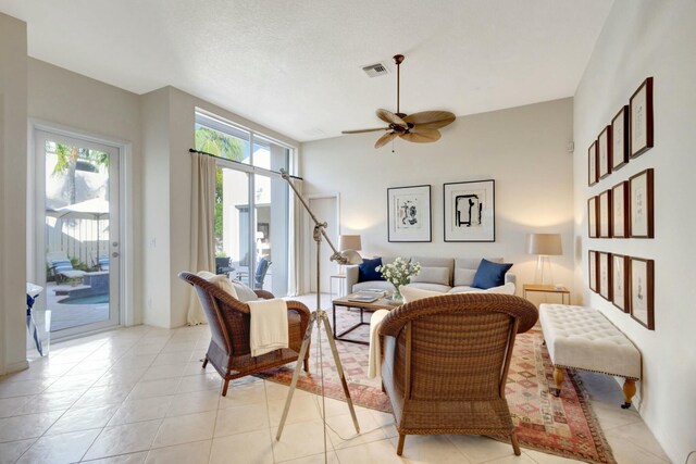 living room with ceiling fan and light tile patterned flooring