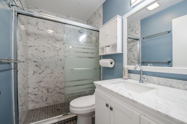 bathroom featuring vanity, toilet, and walk in shower