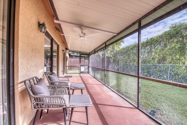 sunroom featuring ceiling fan and plenty of natural light