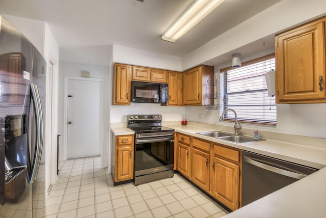 kitchen with light tile patterned floors, sink, and black appliances