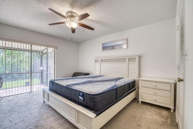 carpeted bedroom featuring a textured ceiling, access to outside, and ceiling fan