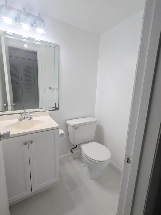 bathroom featuring toilet, vanity, and tile patterned floors