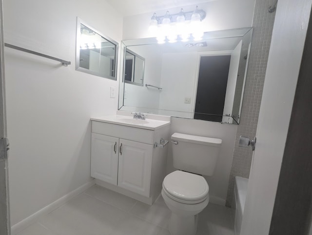 bathroom with toilet, vanity, and tile patterned floors