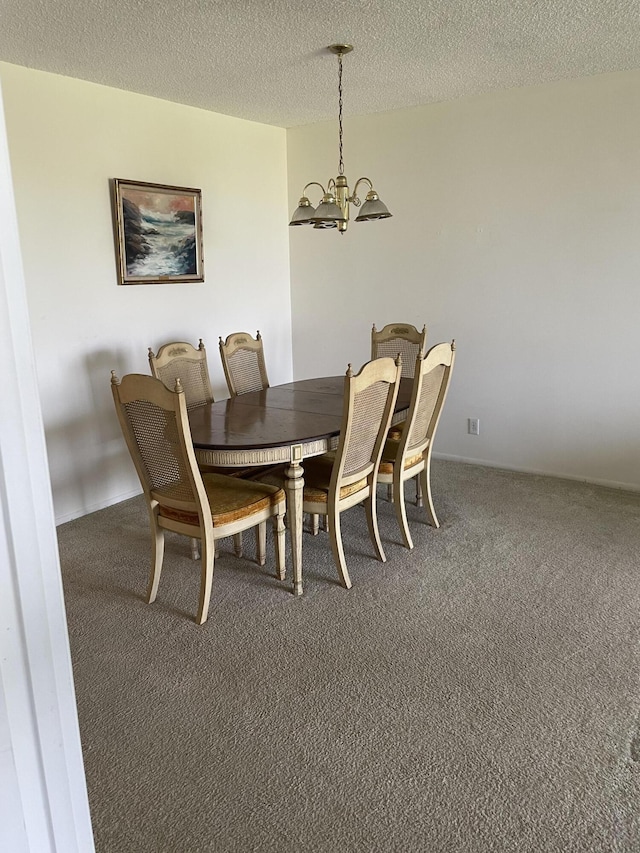 dining space with carpet, a textured ceiling, and an inviting chandelier