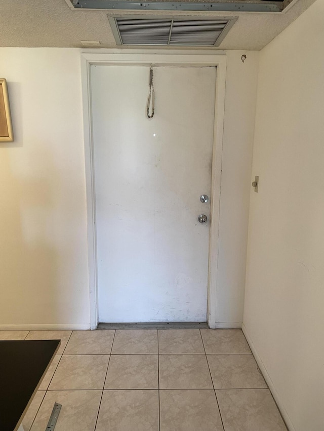 entryway featuring light tile patterned floors