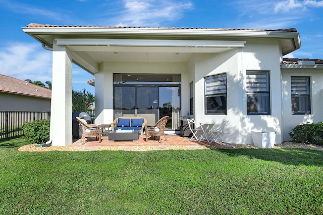 back of property with outdoor lounge area, a patio, and a lawn