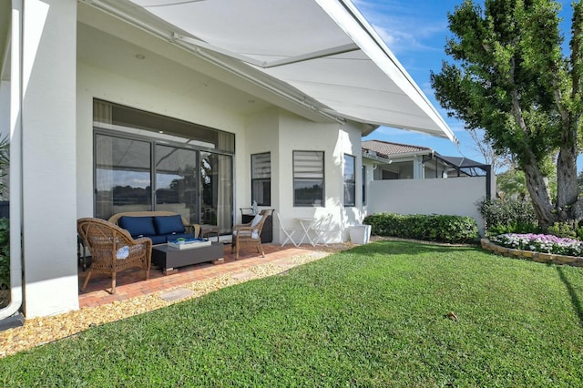 back of property with a lawn, an outdoor living space, and a patio