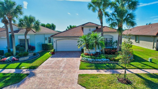 mediterranean / spanish-style home with a garage and a front yard