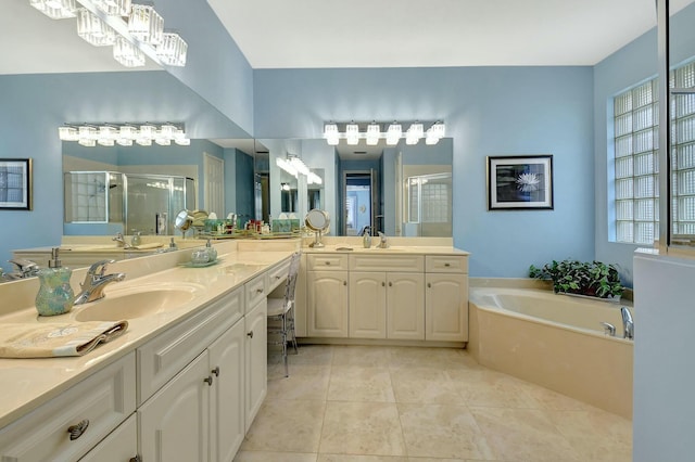 bathroom with tile patterned floors, vanity, and shower with separate bathtub