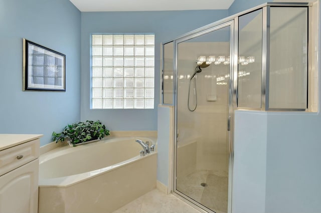 bathroom with tile patterned flooring, vanity, and plus walk in shower