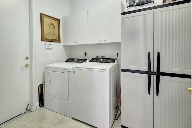 laundry room featuring cabinets and separate washer and dryer