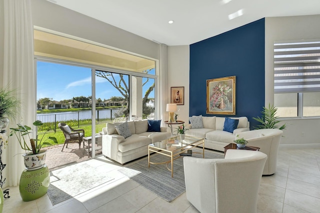 tiled living room with a water view and a healthy amount of sunlight