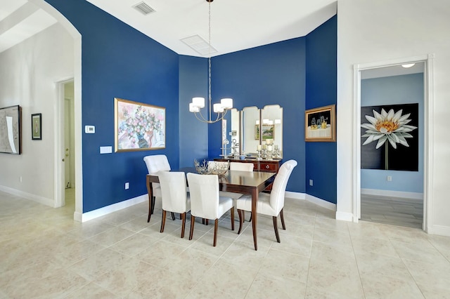 tiled dining space featuring an inviting chandelier