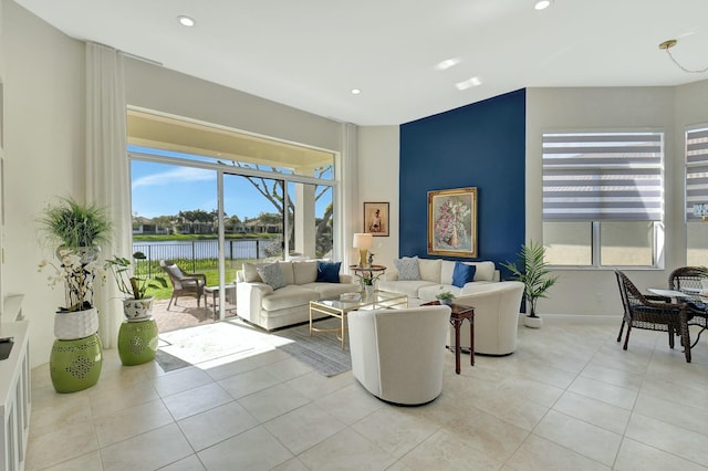 tiled living room featuring a water view