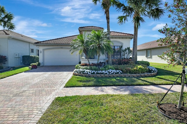 mediterranean / spanish house with a front lawn and a garage