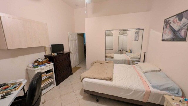 bedroom featuring ceiling fan and high vaulted ceiling