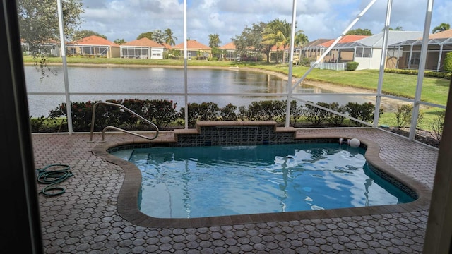 view of swimming pool with a yard and a water view