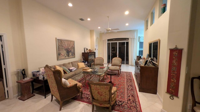 tiled living room featuring ceiling fan