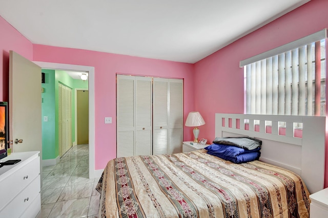 bedroom with a closet and baseboards