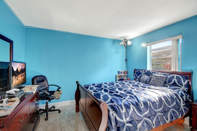 bedroom with baseboards, a chandelier, and a textured ceiling