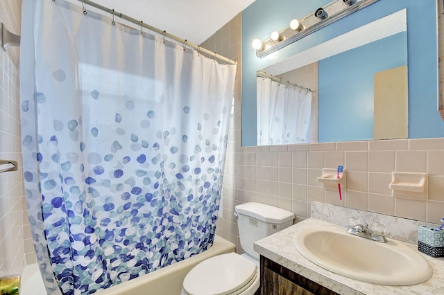 full bath with shower / bath combo, tile walls, toilet, and vanity