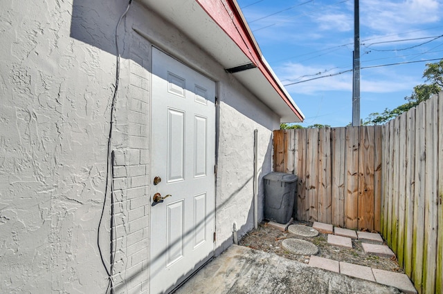 view of side of property featuring fence and stucco siding