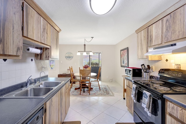 kitchen featuring pendant lighting, black appliances, sink, light tile patterned floors, and a notable chandelier