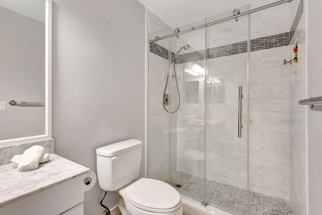 bathroom featuring vanity, toilet, and walk in shower