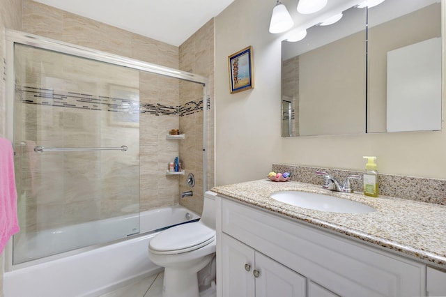 full bathroom featuring shower / bath combination with glass door, tile patterned flooring, vanity, and toilet