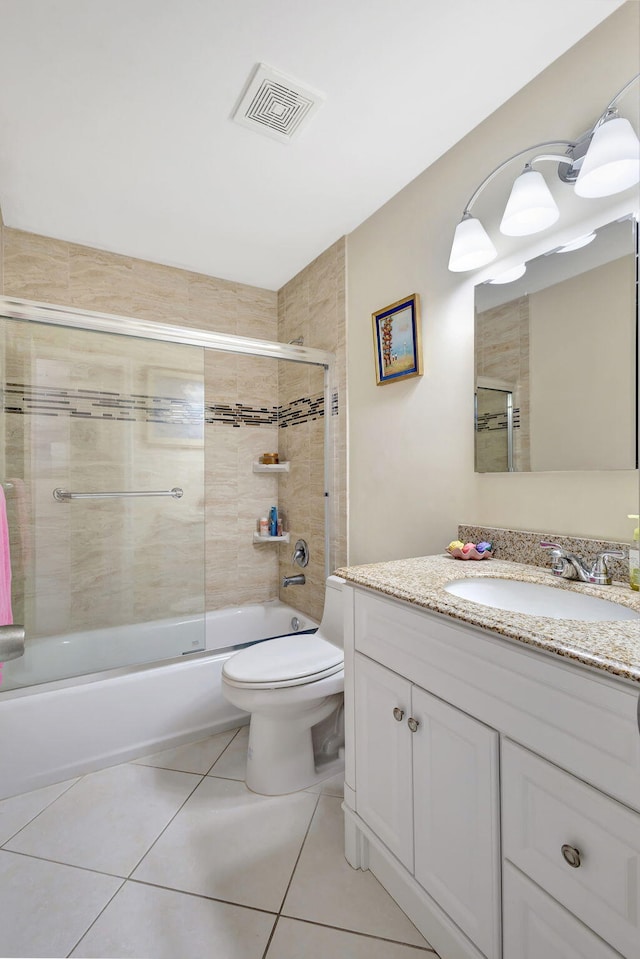 full bathroom featuring toilet, tile patterned flooring, vanity, and combined bath / shower with glass door