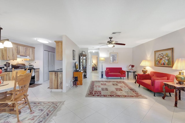 tiled living room featuring ceiling fan