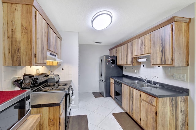 kitchen featuring backsplash, sink, light tile patterned flooring, and black appliances