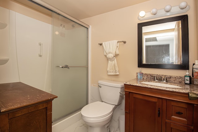 bathroom featuring vanity, an enclosed shower, and toilet