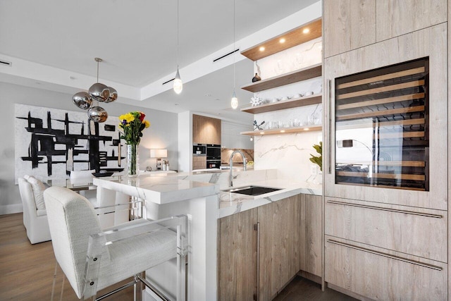 kitchen featuring tasteful backsplash, wine cooler, kitchen peninsula, and sink