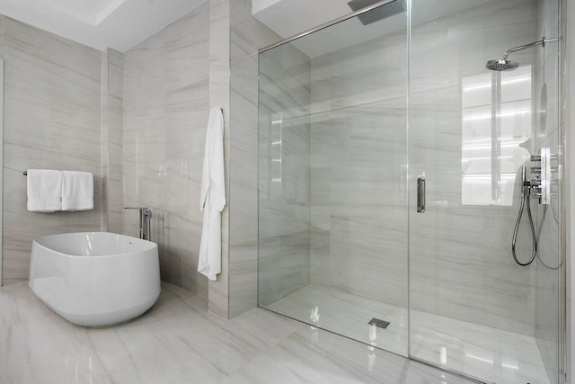 bathroom featuring shower with separate bathtub