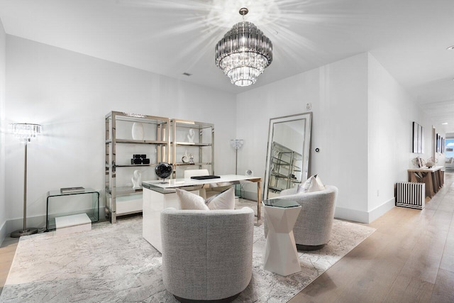 living room featuring light wood-type flooring and an inviting chandelier