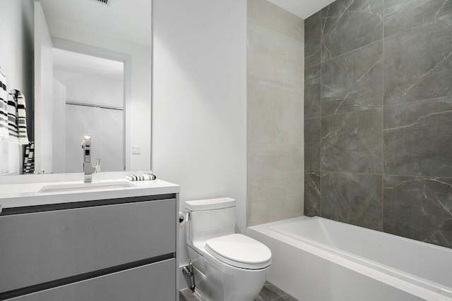 full bathroom featuring toilet, vanity, and tiled shower / bath