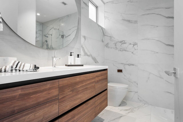 bathroom with a shower with door, tile walls, toilet, and vanity