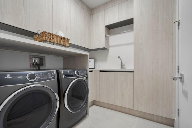 laundry room with light tile patterned floors, sink, and washer and clothes dryer