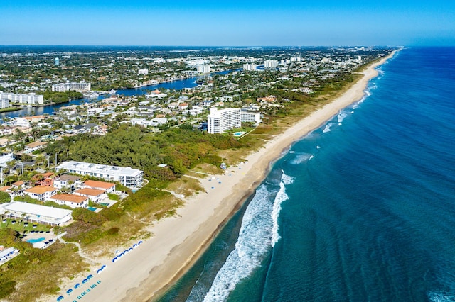 bird's eye view with a water view and a beach view