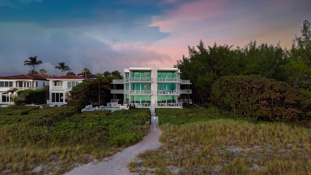 view of back house at dusk