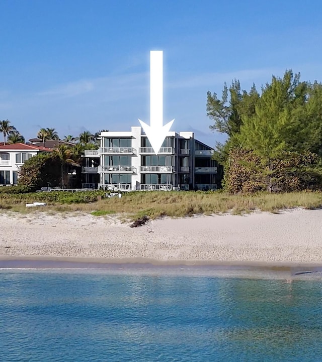 view of swimming pool with a water view and a view of the beach