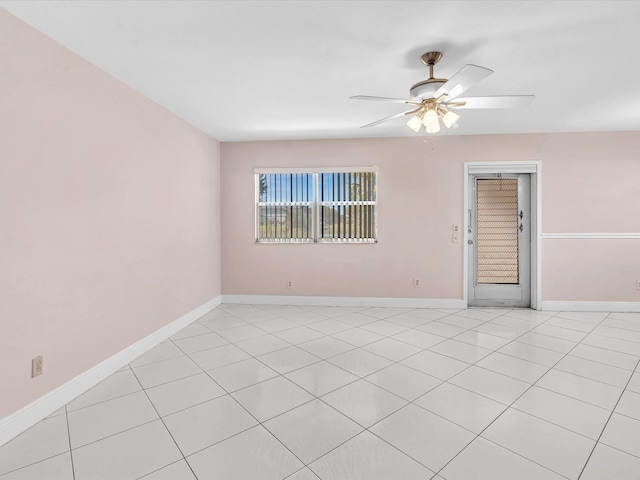 tiled spare room with ceiling fan