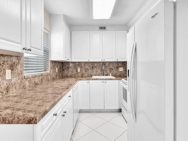 kitchen featuring white cabinetry, sink, white appliances, decorative backsplash, and light tile patterned flooring