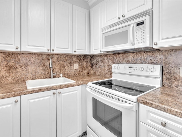 kitchen featuring decorative backsplash, sink, white cabinets, and white appliances