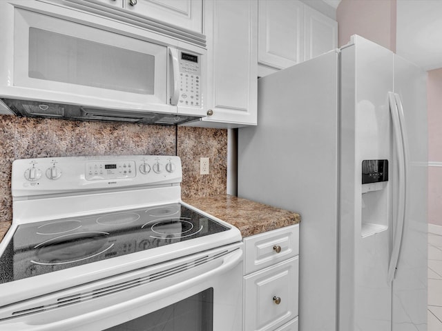 kitchen featuring white appliances, white cabinetry, and backsplash