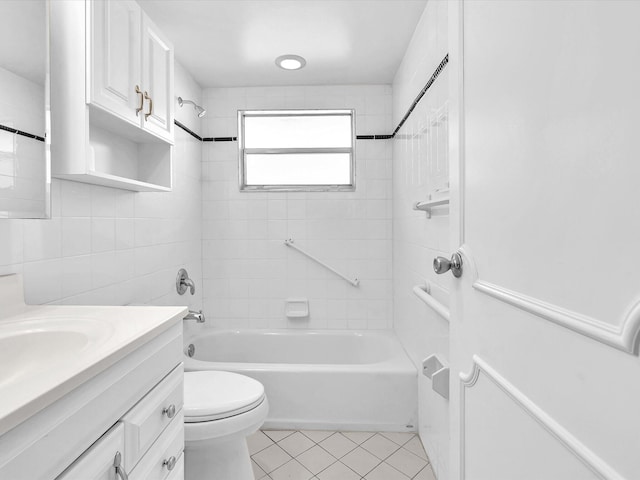 full bathroom with tile patterned floors, vanity, tiled shower / bath combo, and toilet