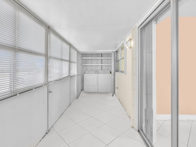 interior space with washing machine and clothes dryer, built in shelves, and light tile patterned floors