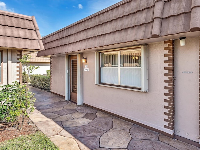 property entrance featuring a patio area