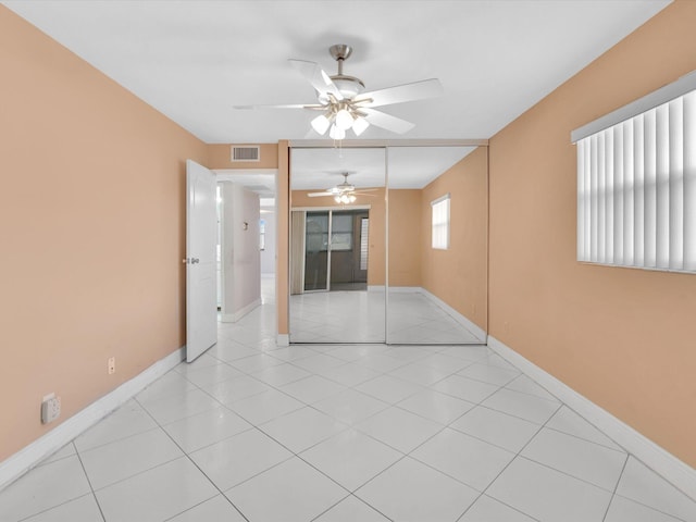 unfurnished room featuring ceiling fan and light tile patterned floors